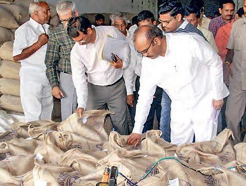 Minister P Pulla Rao inspecting rice bags at a rice mill in Penugonda mandal on Tuesday | Express