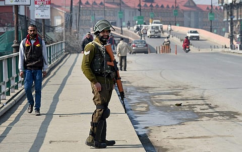 A CRPF jawan guarding a street during a strike call given by separatist groups to protest against the alleged civilian killings in Srinagar on Monday.(Photo | PTI)