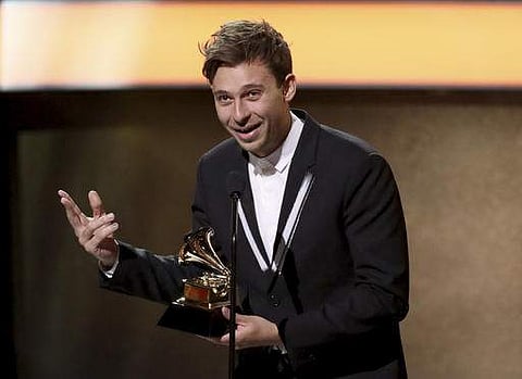 Flume accepts the award for best dance/electronic album for 'Skin' at the 59th annual Grammy Awards. (AP)