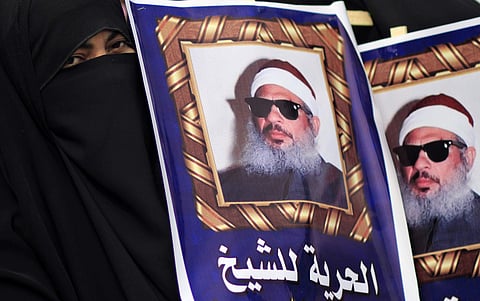In this Feb. 26, 2012 file photo, Egyptian protesters hold posters showing Sheikh Omar Abdel-Rahman, who is imprisoned in the US, and call for his release outside a court in Cairo, Egypt. | AP