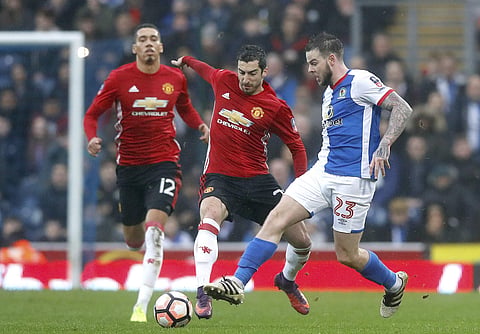 Manchester United's Henrikh Mkhitaryan, left, and Blackburn Rovers' Danny Guthrie, right, battle for the ball during the English FA Cup, Fifth Round soccer match at Ewood Park, Blackburn, England. Sunday Feb 19, 2017. | AP