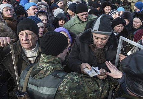 Local residents queue to get humanitarian aid at the humanitarian aid center in Avdiivka, eastern Ukraine | AP