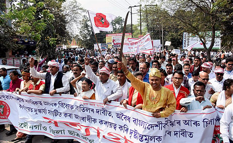 Activists of All Assam Students' Union AASU taking out a Satyagrah rally in Nagaon district of Assam on Friday in protest against alleged vandalisation of AASU office at Silapathar by the members of a Benagali organisation.(Photo | PTI)