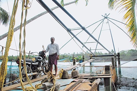 K K Sreenivasan operating the mechanised Chinese fishing net in front of his house at Kurumbathuruthu | K Shijith