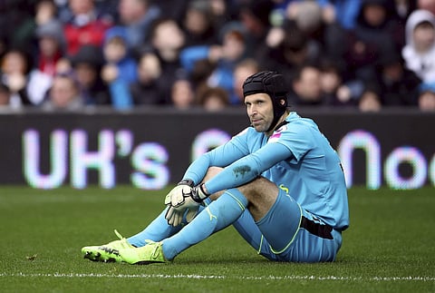 Arsenal goalkeeper Petr Cech sits with an injury, during the English Premier League soccer match between West Bromwich Albion and Arsenal, at The Hawthorns, in West Bromwich, England, Saturday March 18, 2017. | AP