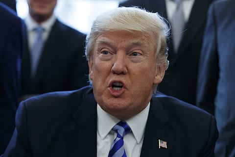 President Donald Trump announces the approval of a permit to build the Keystone XL pipeline, clearing the way for the $8 billion project. AP