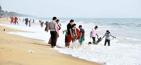 Tourists enjoy the waves at Cherai Beach K Shijith