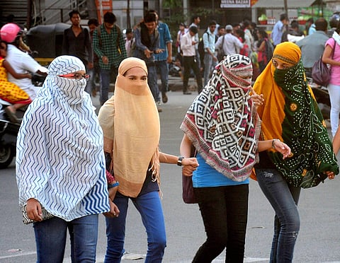 Girls cover their faces to get protection from scorching heat during a hot day in Nagpur Maharashtra on Thursday. | PTI