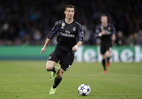 Real Madrid's Cristiano Ronaldo runs with the ball during the Champions League round of 16, second leg, soccer match between Napoli and Real Madrid. (AP)