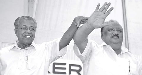Chief Minister Pinarayi Vijayan and newly sworn-in minister Thomas Chandy greet the audience at Raj Bhavan in Thiruvananthapuram on Saturday | Manu R Mavelil