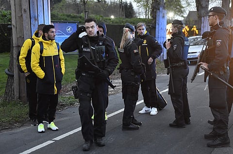 Dortmund's Marcel Schmelzer, third from right, talks to police officers outside the team bus after it was damaged in an explosion before the Champions League quarterfinal soccer match between Borussia Dortmund and AS Monaco. (File | AP)