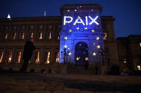 The word Peace (in French) and the logo of the European Union are projected during a light show onto the French Foreign Ministry building to celebrate the 60th anniversary of the Treaty of Rome international agreement that established the creation of the