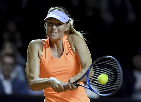 Russian tennis player Maria Sharapova returns the ball to Kristina Mladenovic from France during the Porsche Tennis Grand Prix in Stuttgart, Germany, Saturday, April 29, 2017. | AP