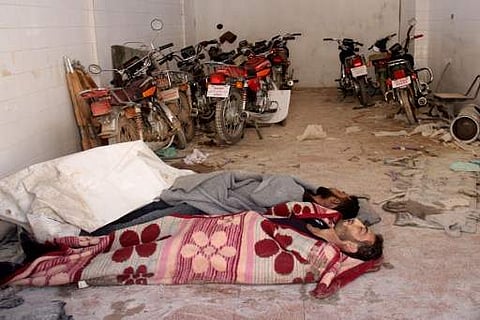 Bodies lie in the parking area of a hospital in Khan Sheikhun, a rebel-held town in the northwestern Syrian Idlib province, following a suspected toxic gas attack on April 4, 2017. (AFP)