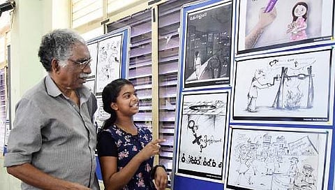 Cartoonists Sera Mariyam Binny and P V Krishnan at the exhibition jointly organised by Kerala Cartoon Academy and Press Club B P Deepu