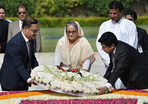 Bangladesh Prime Minister Sheikh Hasina laying a wreath at Mahatma Gandhi's memorial Rajghat in New Delhi on Saturday. | PTI