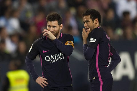 FC Barcelona's Lionel Messi, left, and Neymar da Silva from Brazil, right, gesture during their match against CF Malaga in a Spanish La Liga soccer match between Malaga and Barcelona in Malaga, Spain, Saturday April 8, 2017. | AP
