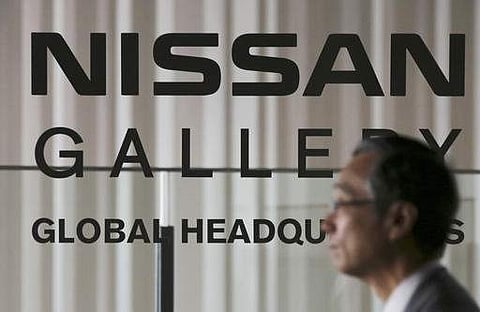 A man walks in front of the logo of Nissan Motor Co. at the gallery at its global headquarters in Yokohama, near Tokyo. (File photo | AP)