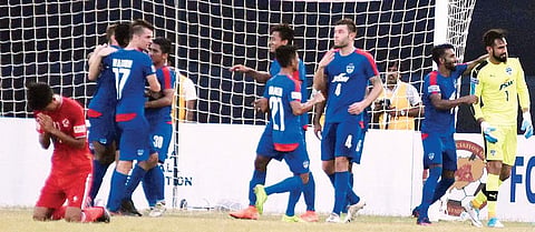 Bengaluru players celebrate their win after keeper Amrinder Singh’s (R) penalty heroics. | (Shamim Qureshy | EPS)
