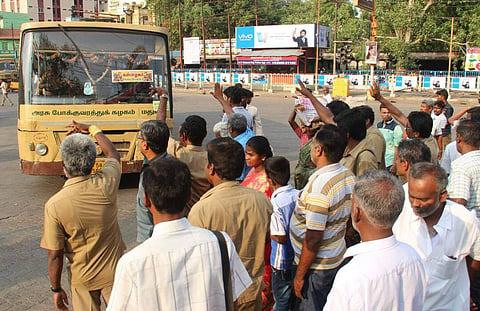 A group of transport employees participating in the strike are letting the city buses to drop the passengers in the Periyar Bus stand and remove the boards stopping the service as a part of their strike at the bus stand on Sunday. (EPS|K Ksundar)