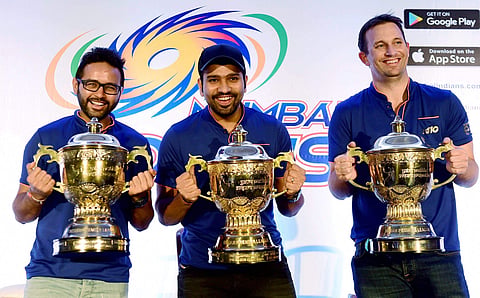 Mumbai Indians captain Rohit Sharma and player Parthiv Patel and Shane Bond pose for media before press conference of their IPL 2017 win in Mumbai on Monday. | PTI
