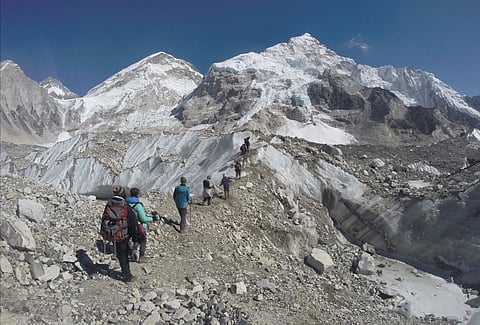 International trekkers pass through a glacier at the Mount Everest base camp, Nepal. (AP)