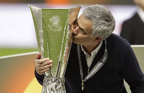 Manchester manager Jose Mourinho kisses the trophy after winning 2-0 during the soccer Europa League final between Ajax Amsterdam and Manchester United at the Friends Arena in Stockholm, Sweden, Wednesday, May 24, 2017. | AP