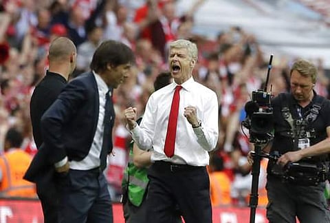 Arsenal team manager Arsene Wenger, right, celebrates his team's victory next to Chelsea team manager Antonio Conte, left, during the English FA Cup final soccer match between Arsenal and Chelsea at the Wembley stadium in London. | AP