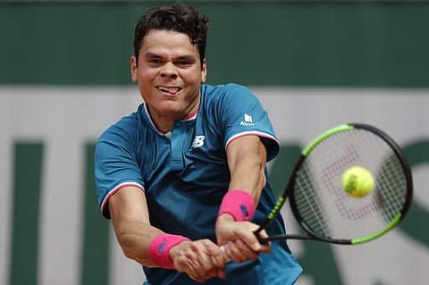 Canada's Milos Raonic returns the ball to Belgium's Steve Darcis during their first round match of the French Open tennis tournament at the Roland Garros stadium. | AP