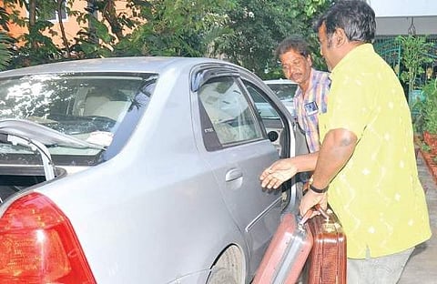 Officials of the Income Tax department with the cash, jewellery and documents seized from Sekhar Reddy’s house in Katpadi. (File | EPS)