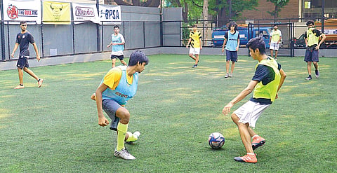 Young men playing a match at Bull Ring futsal court, Indiranagar Pushkar V