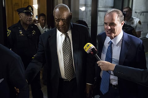 Bill Cosby, center, accompanied by his lawyer Brian McMonagle, walks from the Montgomery County Courthouse during his sexual assault trial in Norristown, Pa., Thursday, June 15, 2017. (AP)