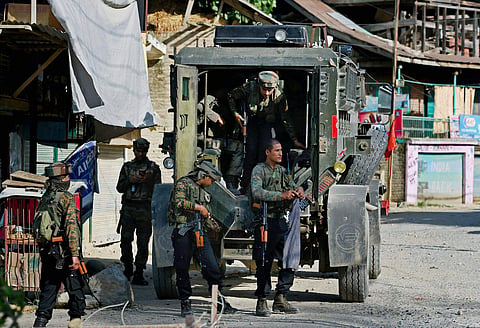 Army jawans stand guard during an encounter with militants at Arwani village of Anantnag district of South Kashmir on Friday. | PTI