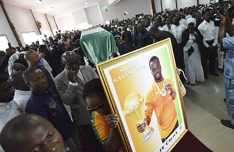 Pallbearers carry the coffin of football star Cheick Tiote, who died in China earlier this month aged 30, during a funeral ceremony on June 18, 2017 in Abidjan. | AFP