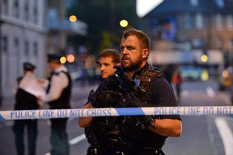 Armed police officers man a cordon in Finsbury Park, north London, where a vehicle struck pedestrians in north London. | AP