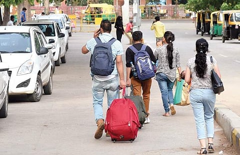 Passengers hauling their luggage at the City Railway Station | Vinod Kumar T
