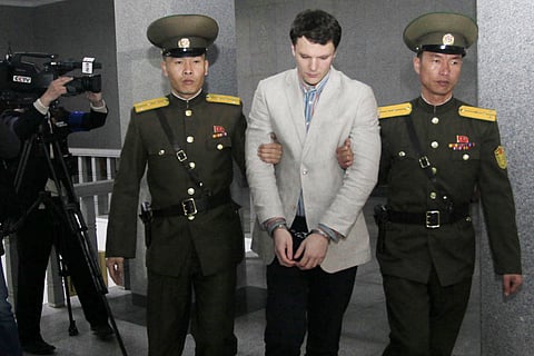 American student Otto Warmbier, center, is escorted at the Supreme Court in Pyongyang, North Korea, Wednesday, March 16, 2016. North Korea's highest court sentenced Warmbier, a 21-year-old University of Virginia undergraduate student, from Wyoming, Ohio,