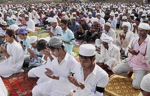 Faridabad Muslims wearing black bands on their arms in protest against the recent lynching incident on board a train offer Eid prayers at village Khandawli on Monday. (PTI)