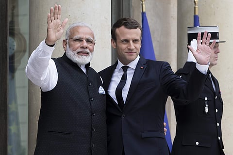 French President Emmanuel Macron, right, welcomes Indian Prime Minister Narendra Modi, before their meeting at the Elysee Palace in Paris. | AP