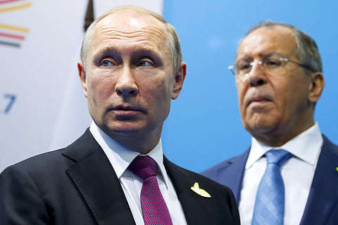 Russian President Vladimir Putin, left, and Foreign Minister Sergey Lavrov stand while waiting for Turkish President Recep Tayyip Erdogan prior to their talks at the G-20 summit in Hamburg, northern Germany, Saturday, July 8, 2017. (AP)