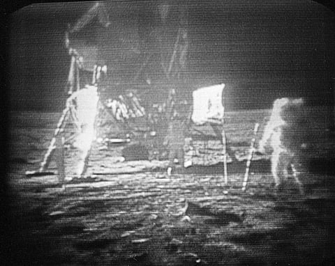 FILE - In this July 20, 1969 file photo, Apollo 11 astronaut Neil Armstrong, right, trudges across the surface of the moon leaving behind footprints. | AP