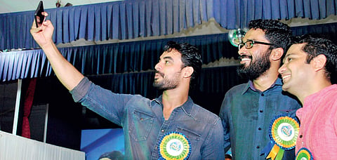 Actor Tovino Thomas capturing a selfie along with Employment Exchange director Sriram Venkitaraman and Hibi Eden MLA during the MLA Award 2017 at St Teresa’s College on Sunday | k Shijith