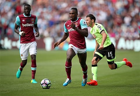 West Ham's Michail Antonio, center, and AFC Bournemouth's Adam Smith (AP)