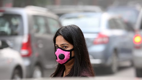 File photo of a woman wearing a face mask to protect against air pollution in New Delhi. (Shekhar Yadav | Express Photo Service)