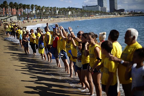 People form a human chain during a protest against tourism in Barcelona, Spain (AP)