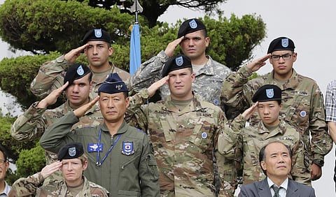 U.S. and South Korean soldiers salute during the South Korea-U.S. Combined Force Command at U.S. military base, in Seoul, South Korea. U.S. and South Korean military officials plan to move ahead with large-scale exercises later this month as North Korea,