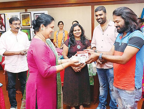 Actor Anand making the first sale at a stall at the expo