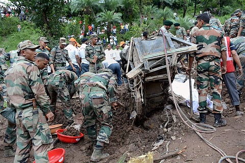 Mandi Rescue and relief works being carried out on Sunday after two buses and some other vehicles were swept away by a massive landslide at Kotrupi in Mandi district on Saturday night. | PTI