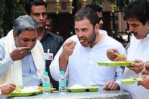 Congress National Vice President Rahul Gandhi and Karntaka Chief Minister Siddaramaih and Karnataka Incharge Venugopal having food after inaugurating the Indhira Canteen at Kanakana Palya in Bengaluru on Wednesday. (Nagesh Polali | EPS)