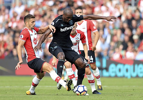 Southampton's Dusan Tadic, left and West Ham United's Angelo Ogbonna battle for the ball, during the English Premier League soccer match between Southampton and West Ham. | AP